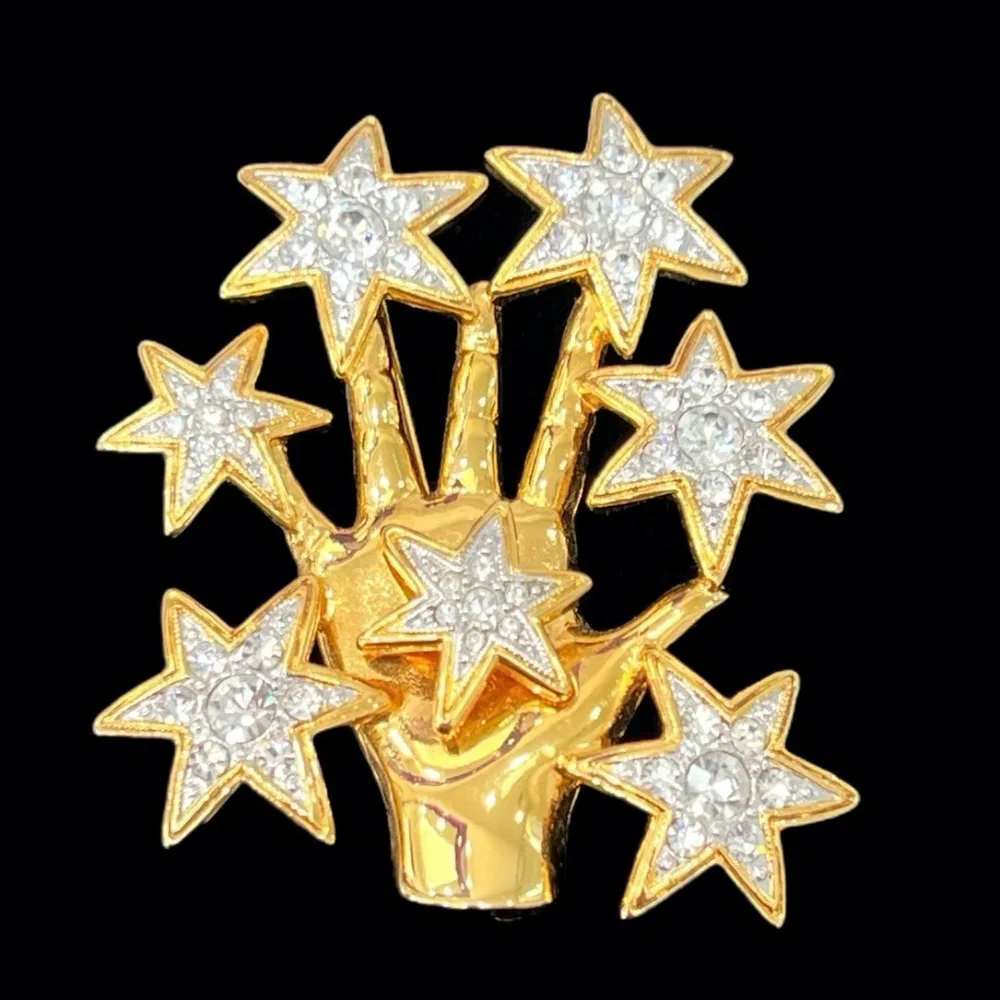 NOLAN MILLER SHINY GOLDEN HAND WITH CRYSTAL STARS BROOCH